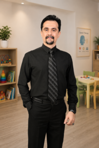 Dr. Azizreza Ghasemzadeh, Speech Therapist in Dubai, standing in a speech therapy clinic